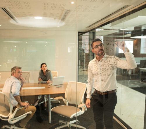 Business meeting man writing on glass teaser