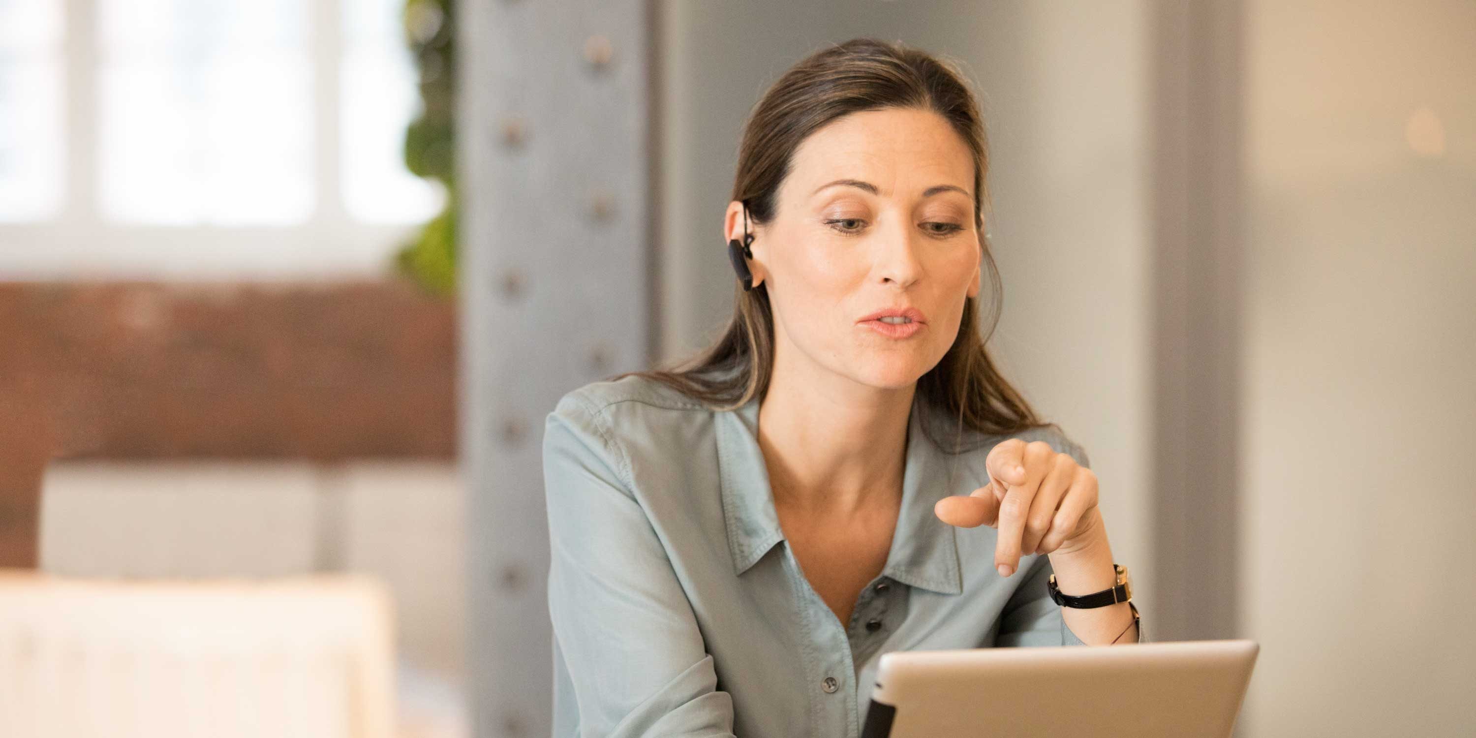 Woman with laptop and head phones stage